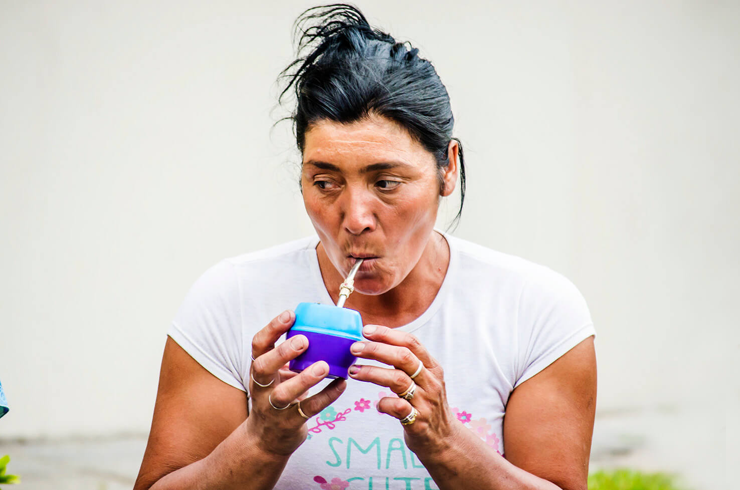 Argentina lady with drinking mate through a straw.