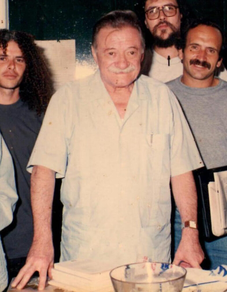 Mario Benedetti standing with other people behind him.